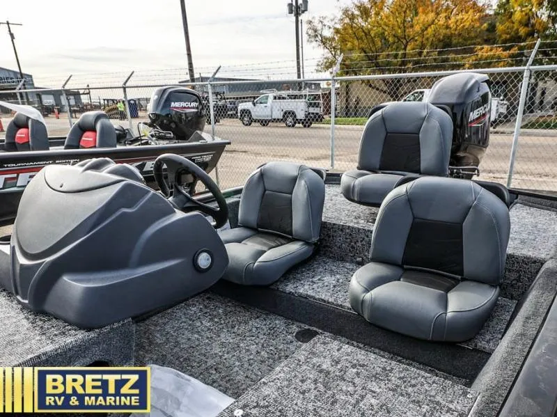 Slide: The Image of Pro 170 boat interior with gray seats and Mercury engine, 2025 model at Bretz RV & Marine. - 13