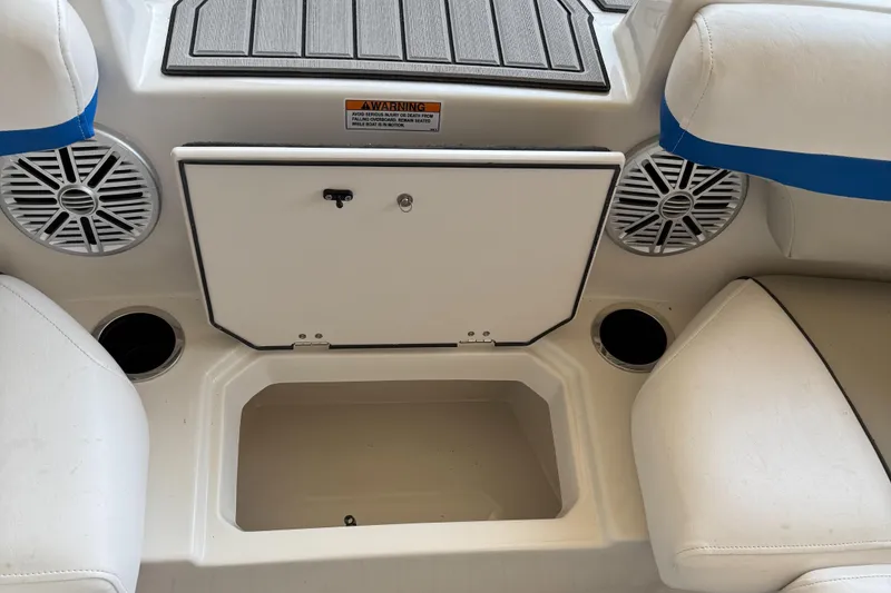 Slide: The Image of 2023 Starcraft SVX 211 OB boat interior with storage compartment and speakers. - 13