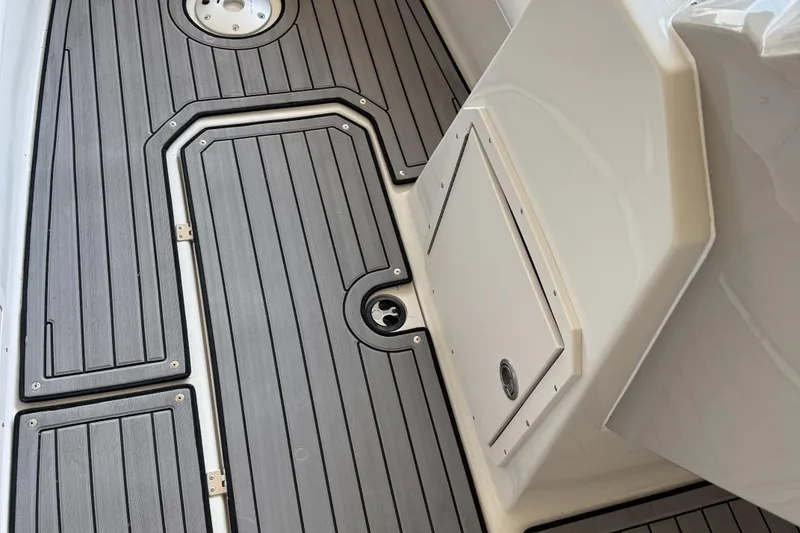 Slide: The Image of 2023 Starcraft SVX 211 OB boat deck with sleek, modern design and storage compartments. - 14