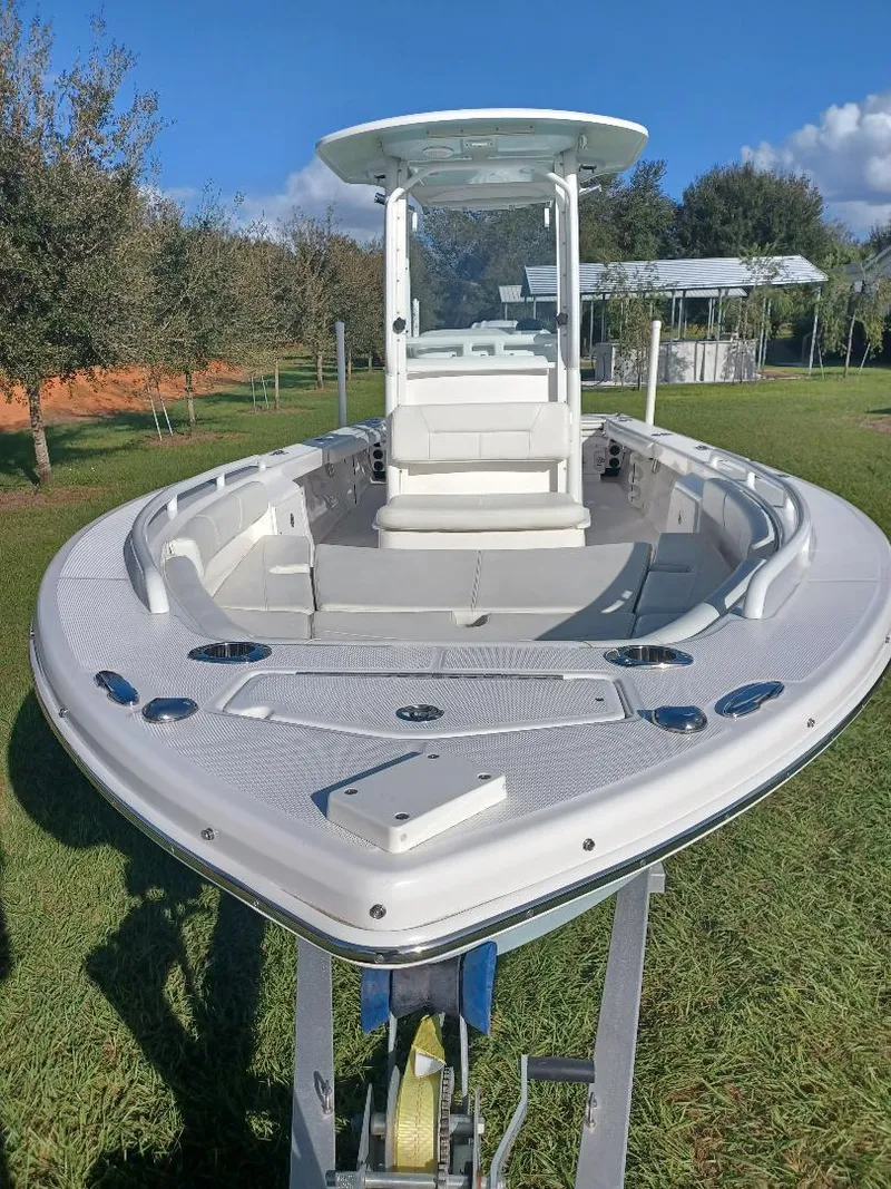 Slide: The Image of 2022 Everglades 243 Center Console boat on trailer, parked on grass. - 4