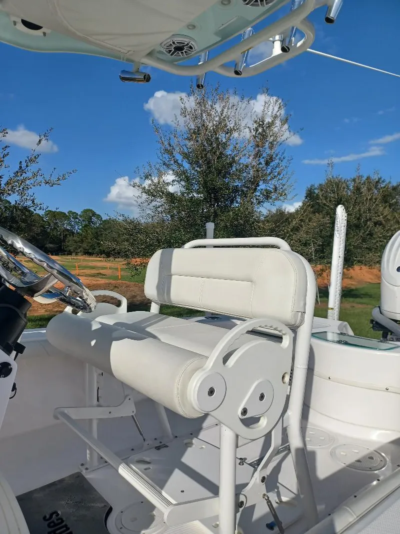 Slide: The Image of 2022 Everglades 243 Center Console boat interior with white seating and steering wheel. - 8