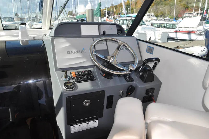 Slide: The Image of 2014 Pursuit OS 315 Offshore helm with Garmin navigation system and comfortable seating. - 10