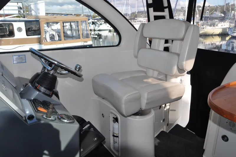 Slide: The Image of Interior of 2014 Pursuit OS 315 Offshore boat with helm seat and steering wheel. - 11