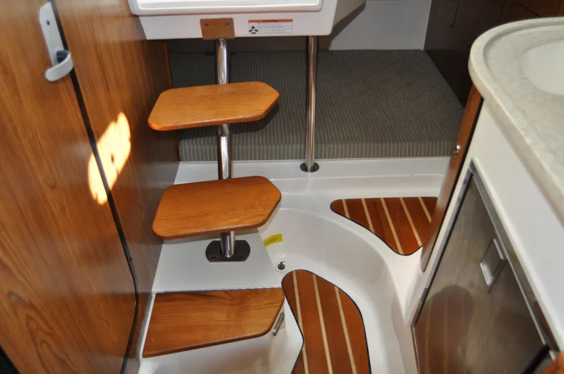 Slide: The Image of Interior of 2014 Pursuit OS 315 Offshore boat with wooden steps and modern design. - 14