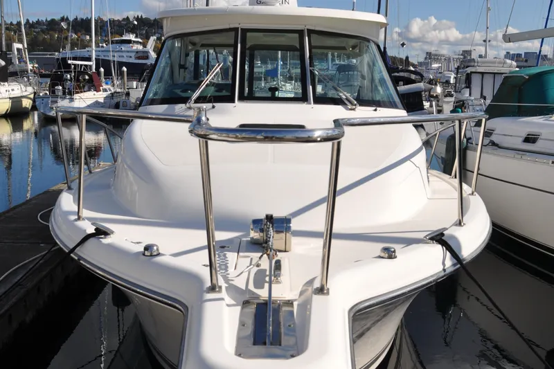 Slide: The Image of 2014 Pursuit OS 315 Offshore boat docked at marina. - 2