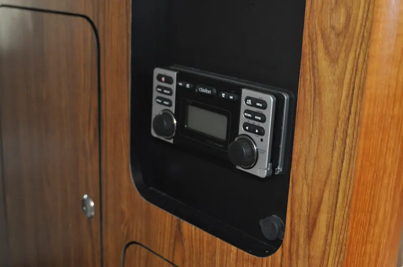 Slide: The Image of Built-in stereo system on 2014 Pursuit OS 315 Offshore boat with wood paneling. - 20