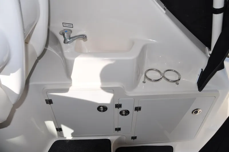 Slide: The Image of 2014 Pursuit OS 315 Offshore boat interior sink and storage area. - 23