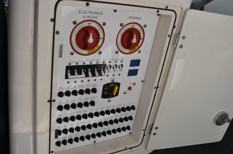 Slide: The Image of Control panel of a 2014 Pursuit OS 315 Offshore boat, featuring switches and dials. - 24