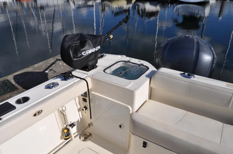 Slide: The Image of 2014 Pursuit OS 315 Offshore boat interior with fishing gear and seating. - 25