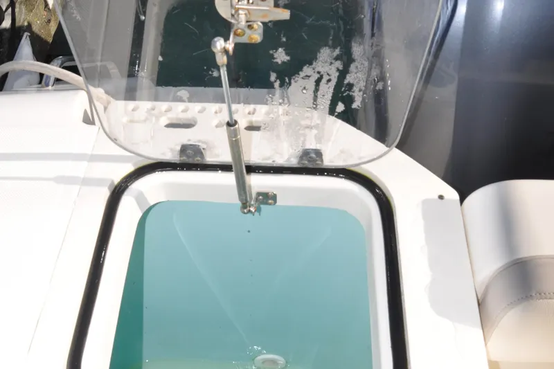 Slide: The Image of Livewell on 2014 Pursuit OS 315 Offshore boat, open lid, filled with water. - 26