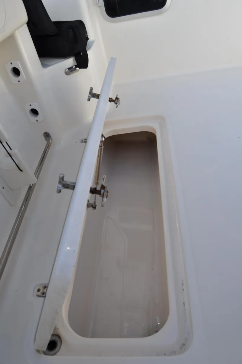 Slide: The Image of 2014 Pursuit OS 315 Offshore boat storage compartment open. - 28