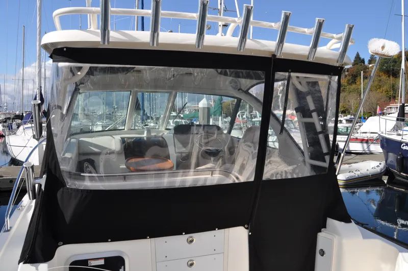 Slide: The Image of 2014 Pursuit OS 315 Offshore boat with covered cockpit in marina. - 3