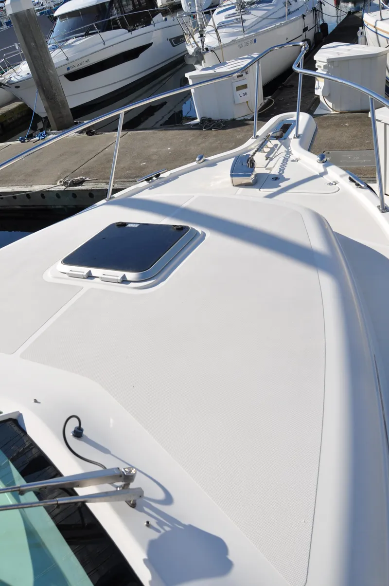 Slide: The Image of 2014 Pursuit OS 315 Offshore boat docked at marina. - 31