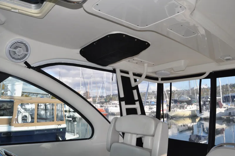 Slide: The Image of Interior of 2014 Pursuit OS 315 Offshore boat with marina view. - 8