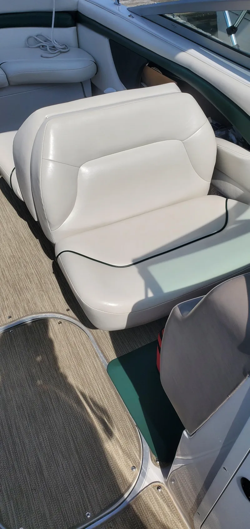 Slide: The Image of 2002 Four Winns 240 Horizon boat interior with white seating and carpeted floor. - 12
