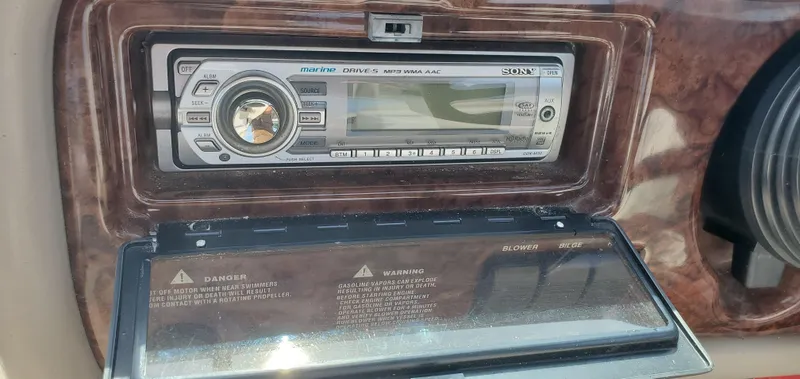 Slide: The Image of 2002 Four Winns 240 Horizon boat stereo system with protective cover open. - 14