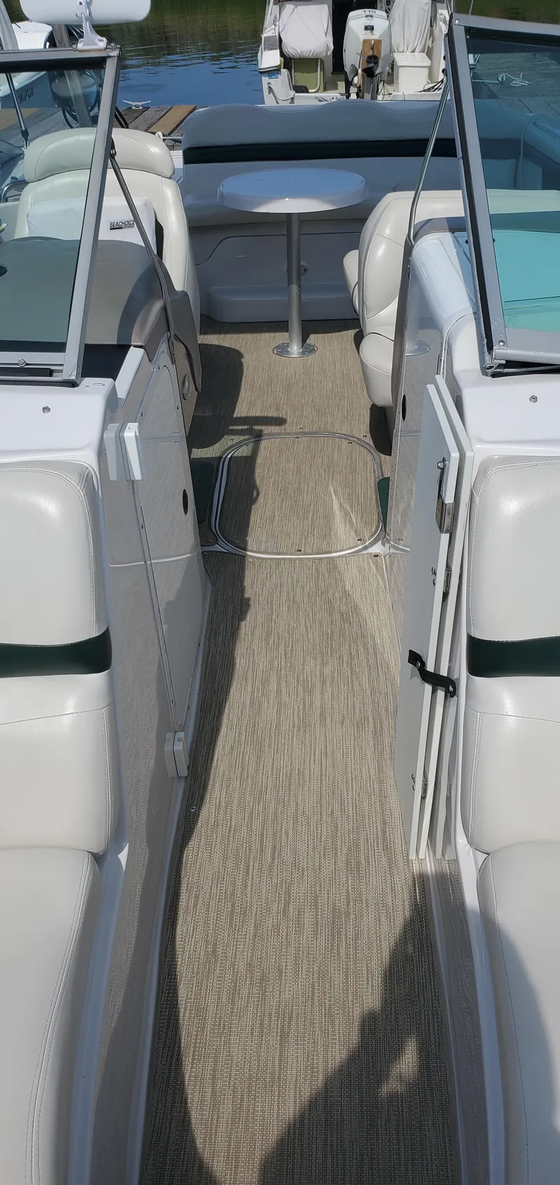Slide: The Image of 2002 Four Winns 240 Horizon boat interior with white seating and open deck. - 15