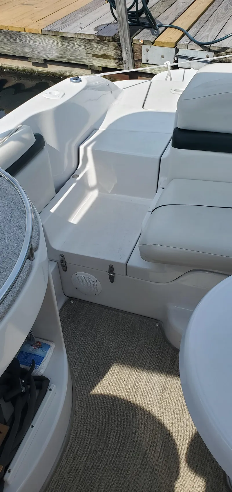Slide: The Image of 2002 Four Winns 240 Horizon boat interior with white seating and deck. - 3