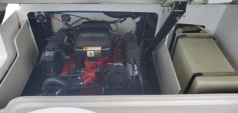 Slide: The Image of 2002 Four Winns 240 Horizon engine compartment with visible components and wiring. - 7