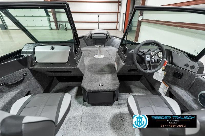 Slide: The Image of 2025 Lund 1775 Adventure Sport boat interior with steering wheel and seating. - 17