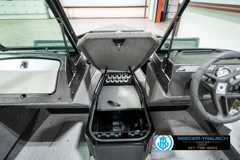Slide: The Image of 2025 Lund 1775 Adventure Sport boat interior with open storage compartment. - 21