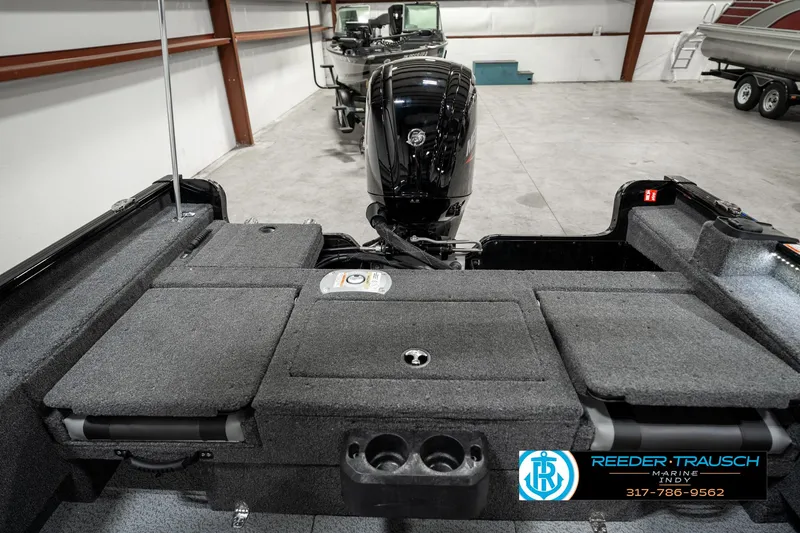 Slide: The Image of 2025 Lund 1775 Adventure Sport boat interior with motor, in a showroom. - 22