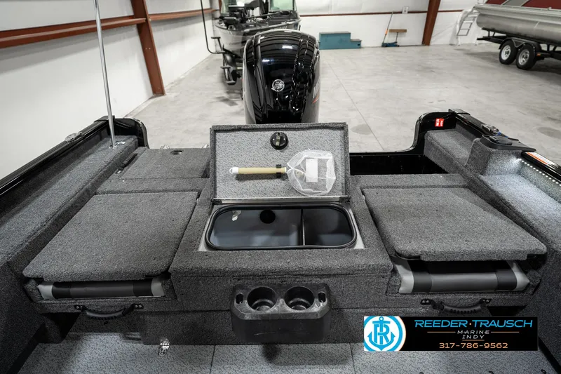 Slide: The Image of 2025 Lund 1775 Adventure Sport boat interior with storage compartments and motor. - 23