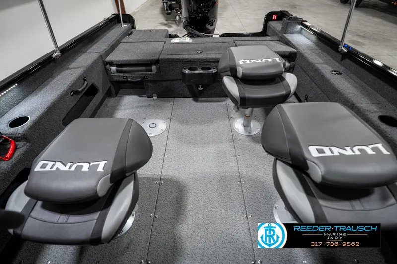 Slide: The Image of 2025 Lund 1775 Adventure Sport interior with three cushioned seats and storage compartments. - 27