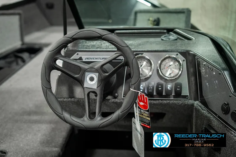Slide: The Image of 2025 Lund 1775 Adventure Sport boat dashboard with steering wheel and gauges. - 28