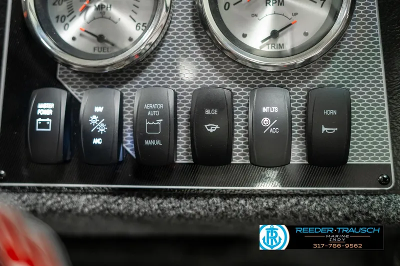 Slide: The Image of Dashboard controls of 2025 Lund 1775 Adventure Sport boat with various switches and gauges. - 31