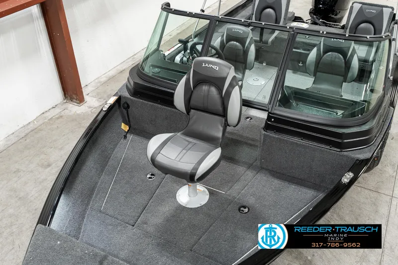Slide: The Image of 2025 Lund 1775 Adventure Sport boat interior with swivel seat, gray upholstery, and windshield. - 8