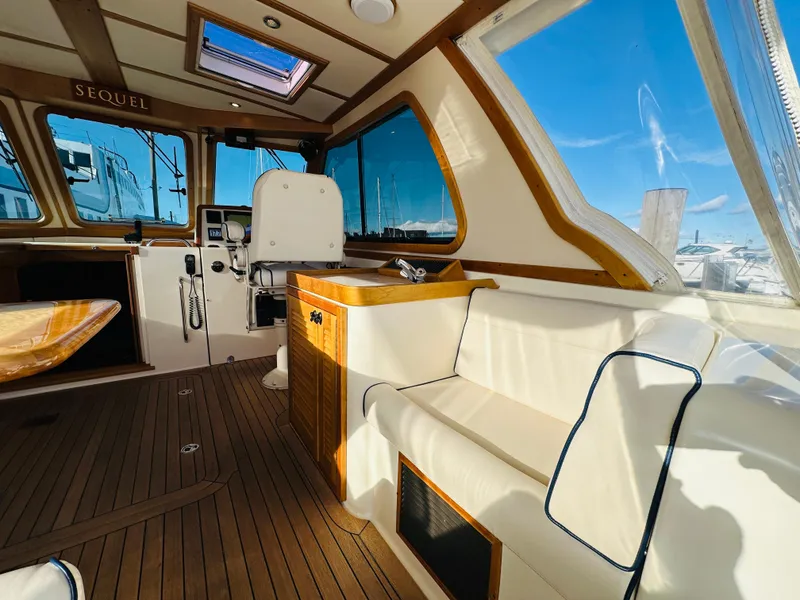 Slide: The Image of Interior of 2009 Sabre 42 Hardtop Express yacht with wooden flooring and white seating. - 10