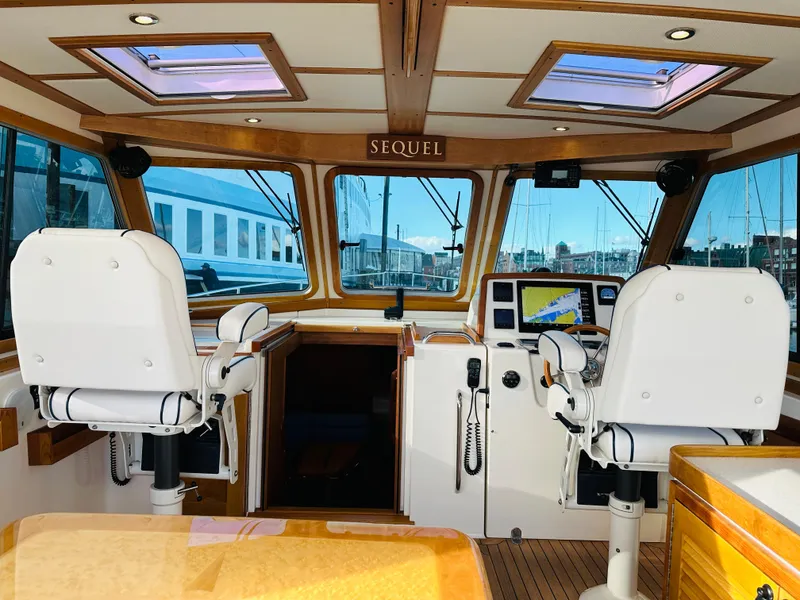 Slide: The Image of Interior of 2009 Sabre 42 Hardtop Express yacht with helm and navigation equipment. - 11
