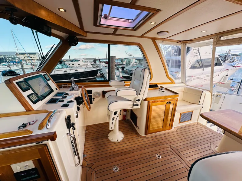 Slide: The Image of 2009 Sabre 42 Hardtop Express helm with luxurious seating and advanced navigation controls. - 13