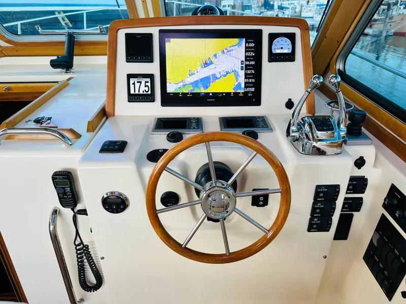 Slide: The Image of 2009 Sabre 42 Hardtop Express helm with navigation display and controls. - 18