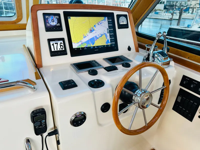 Slide: The Image of 2009 Sabre 42 Hardtop Express helm with navigation display and controls. - 20