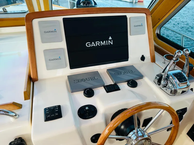 Slide: The Image of 2009 Sabre 42 Hardtop Express helm with Garmin navigation system and wooden steering wheel. - 21