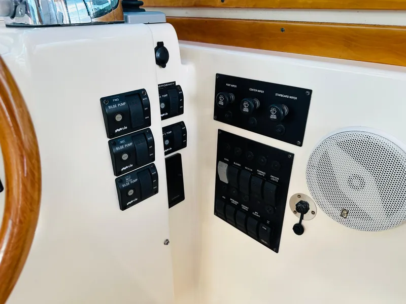 Slide: The Image of 2009 Sabre 42 Hardtop Express control panel with switches and speaker. - 22