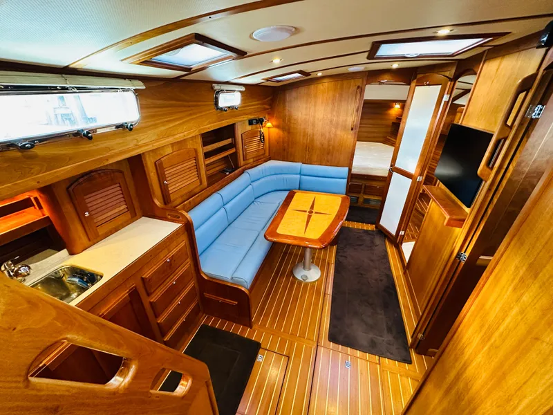 Slide: The Image of Luxurious interior of 2009 Sabre 42 Hardtop Express yacht with wood finish and blue seating. - 25