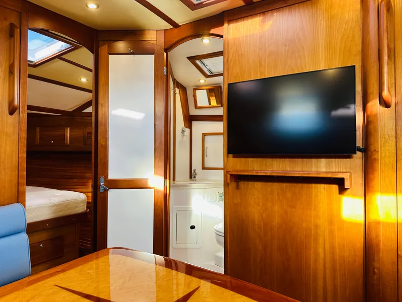 Slide: The Image of Luxurious interior of 2009 Sabre 42 Hardtop Express yacht with wood finish and TV. - 32