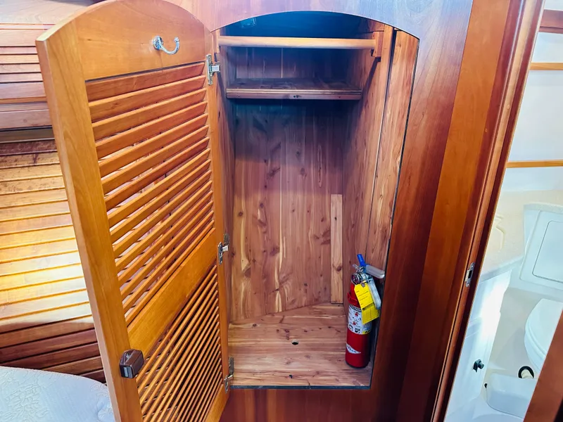 Slide: The Image of Wooden closet interior with fire extinguisher on a 2009 Sabre 42 Hardtop Express yacht. - 36