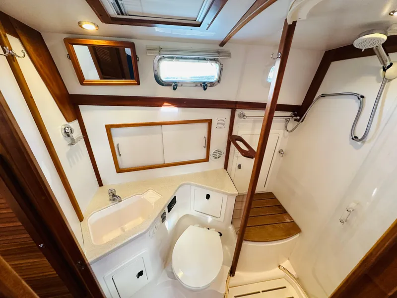 Slide: The Image of Luxurious 2009 Sabre 42 Hardtop Express yacht bathroom with shower and wooden accents. - 40