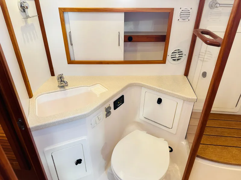 Slide: The Image of 2009 Sabre 42 Hardtop Express bathroom with sink, toilet, and storage cabinets. - 41