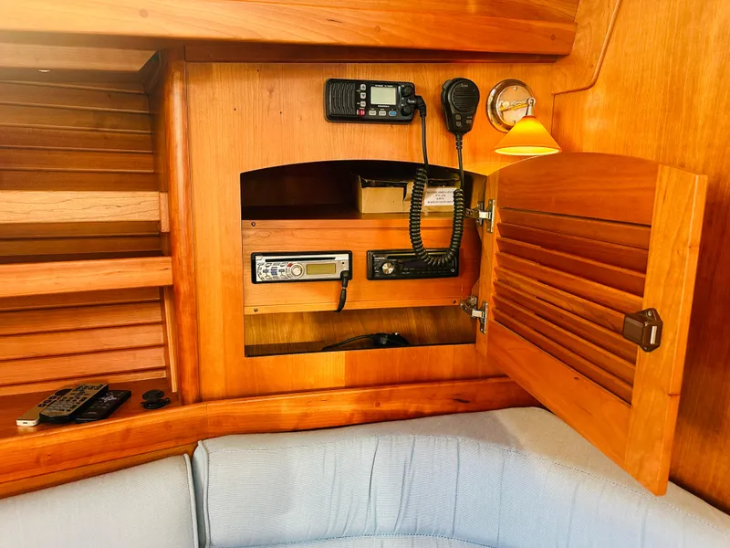 Slide: The Image of 2009 Sabre 42 Hardtop Express interior with wooden cabinet and communication equipment. - 42