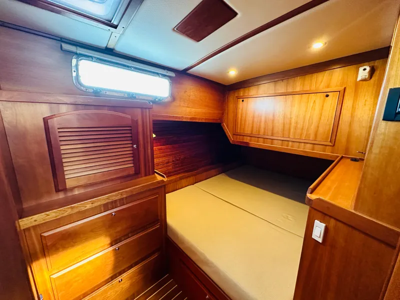 Slide: The Image of 2009 Sabre 42 Hardtop Express cabin with wooden interior and cozy bed. - 43