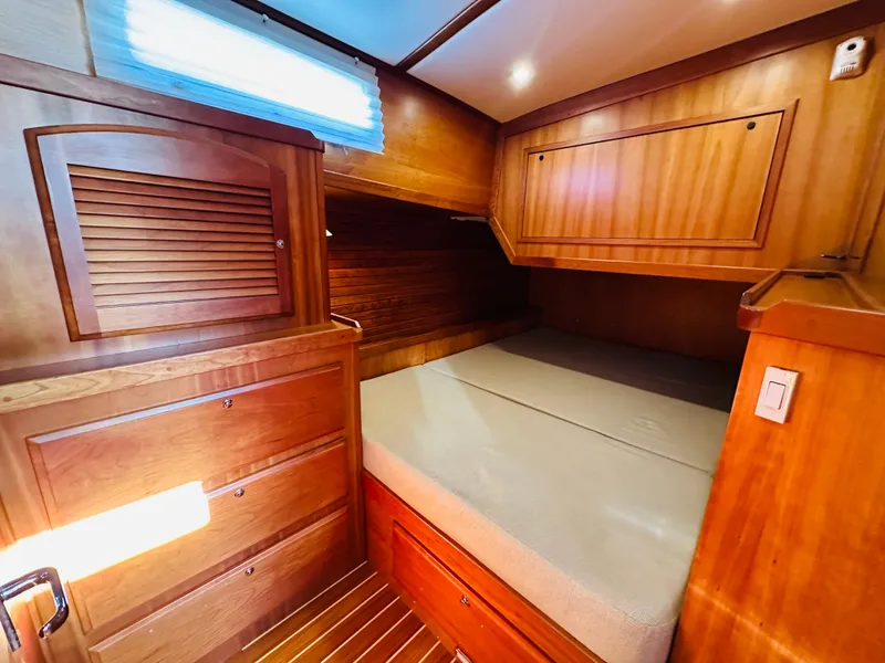 Slide: The Image of Cozy cabin interior of 2009 Sabre 42 Hardtop Express with wooden cabinetry and bed. - 44