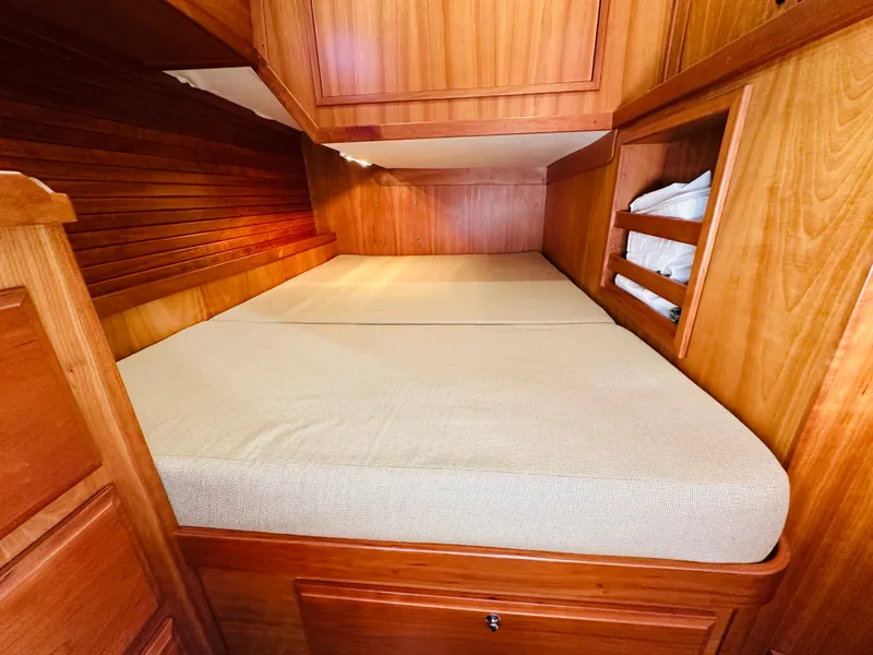 Slide: The Image of 2009 Sabre 42 Hardtop Express cabin with wooden interior and cozy bed. - 46