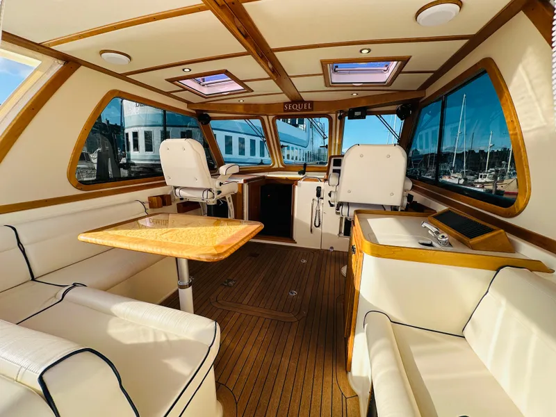 Slide: The Image of Interior of 2009 Sabre 42 Hardtop Express yacht with elegant seating and wooden accents. - 8
