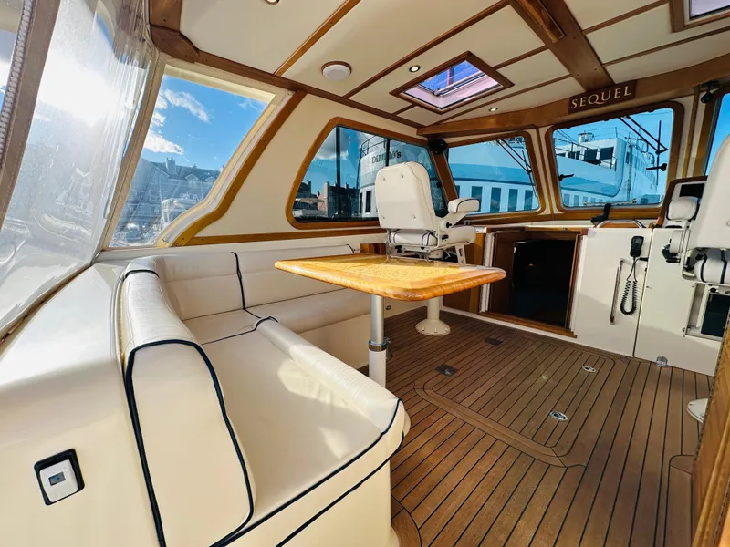 Slide: The Image of Interior of 2009 Sabre 42 Hardtop Express yacht with wood accents and seating. - 9