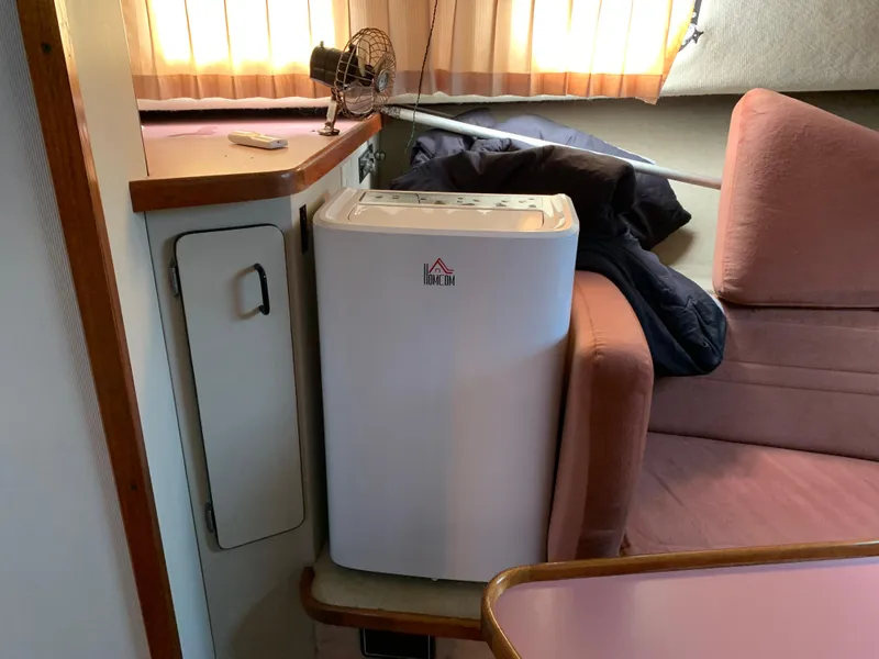 Slide: The Image of Interior of 1986 Carver 28 Riviera with compact appliance and seating area. - 11